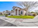 Front exterior elevation of a home with a well-manicured lawn, mature tree, and desert landscaping at 3591 S Larkspur Way, Chandler, AZ 85248