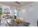 Dining area featuring a modern chandelier, a long table, and lots of natural light at 4453 E Whitney Ln, Phoenix, AZ 85032