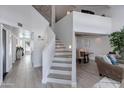 Bright, open-concept home featuring a staircase with white risers and gray treads at 4453 E Whitney Ln, Phoenix, AZ 85032