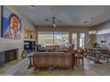 Spacious living room with a fireplace, mountain views, and a pool at 6788 E Nightingale Star Cir, Scottsdale, AZ 85266