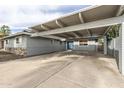 Home exterior featuring covered carport, light blue painted walls and blue front door at 7018 E Wilshire Dr, Scottsdale, AZ 85257