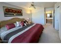 Relaxing bedroom featuring a comfortable bed, ceiling fan and ensuite bathroom at 8260 E Keats Ave # 500, Mesa, AZ 85209