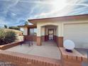 Inviting front porch with brick accents, bench seating, and a decorative lawn ornament at 8260 E Keats Ave # 500, Mesa, AZ 85209