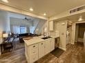 Open concept kitchen with island and views into living room at 850 S River Dr # 1002, Tempe, AZ 85281