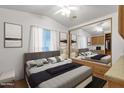 Main bedroom with mirrored closet and gray bedding at 8700 E University Dr # 2216, Mesa, AZ 85207