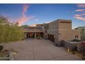 Desert home featuring a tile roof, desert landscaping, and a spacious driveway leading to a large garage at 9290 E Thompson Peak Pkwy # 444, Scottsdale, AZ 85255