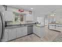 Spacious kitchen featuring granite countertops and white cabinets at 9890 N Balboa Dr, Sun City, AZ 85351