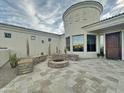 Beautiful outdoor living space features a stone fire pit, stone benches and travertine patio at 11429 S Wilson Ln, Goodyear, AZ 85338