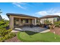 Covered patio, putting green, and grassy area at 13442 W Blackstone Ln, Peoria, AZ 85383