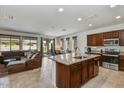 Open floor plan with kitchen island and spacious living room at 13442 W Blackstone Ln, Peoria, AZ 85383