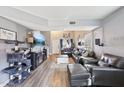 Open living area with gray leather furniture and a large TV at 14885 W Caribbean Ln, Surprise, AZ 85379