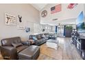 Spacious living room with hardwood floors and a large TV at 14885 W Caribbean Ln, Surprise, AZ 85379