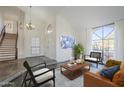 Bright and airy living room featuring tile floors, soaring ceilings, large windows, and neutral colors at 15857 N 51St Pl, Scottsdale, AZ 85254