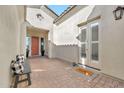 Cozy front courtyard with brick flooring, bench, and neutral tones at 21284 W Hillcrest Blvd, Buckeye, AZ 85396