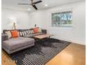 Bright living room featuring a sectional sofa and wood-look floors at 2317 W Whitton Ave, Phoenix, AZ 85015