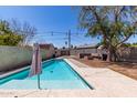 Inviting swimming pool with a spacious backyard and patio area at 2317 W Whitton Ave, Phoenix, AZ 85015