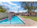 Inviting swimming pool with a spacious backyard and patio area at 2317 W Whitton Ave, Phoenix, AZ 85015