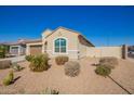 Beautiful single story home with low maintenance desert landscaping, with a blue sky above at 24338 W Albeniz Pl, Buckeye, AZ 85326