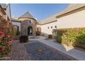 Charming courtyard entry with a central fountain and brick walkway at 2706 E Lovebird Ln, Gilbert, AZ 85297