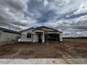 Construction of a single-story home featuring a two-car garage and covered entry, showcasing the framing stage at 32693 N Newby Dr, San Tan Valley, AZ 85143