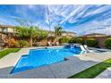 Gorgeous backyard pool with a water feature, tanning deck, and lush landscaping at 3320 E Tina Dr, Phoenix, AZ 85050