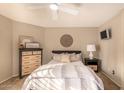 Cozy bedroom with a ceiling fan, neutral decor, a comfortable bed, and two matching nightstands at 3801 E Kent Dr, Phoenix, AZ 85044