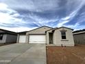 Charming single-story home featuring a three car garage and neutral stucco exterior at 4328 E Bradford Ave, San Tan Valley, AZ 85140