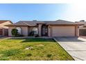 Charming home featuring a well-manicured lawn and a two-car garage at 4507 E Towne Ln, Gilbert, AZ 85234