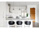 Modern kitchen with white cabinets and marble countertops at 6166 N Scottsdale Rd # C2008, Paradise Valley, AZ 85253