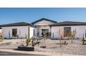 White modern home with gray roof and drought-tolerant landscaping at 7130 E Saddleback St # 11, Mesa, AZ 85207