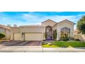 Tan two-story home with a tile roof, landscaping, and a two-car garage at 7439 E Beryl Ave, Scottsdale, AZ 85258