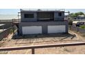 Container home with double garage doors and a large unfinished yard at 9428 N 9Th Ave, Phoenix, AZ 85021