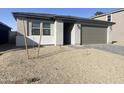 Well-maintained single-story home with xeriscape front yard and paved driveway at 9526 W Luxton Ln, Tolleson, AZ 85353