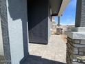 Side view of house showcasing gray siding and stone accents at 9530 W Luxton Ln, Tolleson, AZ 85353