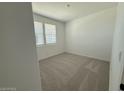 Cozy bedroom with plush carpeting and bright natural light from the double window at 9534 W Luxton Ln, Tolleson, AZ 85353