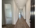 Inviting hallway with wood-look tile flooring leads into the home's main living areas at 9534 W Luxton Ln, Tolleson, AZ 85353