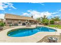 Beautiful pool, lush landscaping, and covered patio, ideal for outdoor living and entertaining in style at 10971 W Tonopah Dr, Peoria, AZ 85373