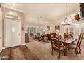 Cozy living room featuring neutral decor, plantation shutters, and a comfortable seating area at 10971 W Tonopah Dr, Peoria, AZ 85373