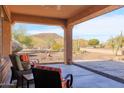 Covered patio with seating area and mountain views at 13050 W Pinnacle Vista Dr, Peoria, AZ 85383