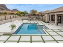 A beautiful backyard pool area with built-in outdoor kitchen, grill, pizza oven, and mountain views at 13370 E Del Timbre Dr, Scottsdale, AZ 85259