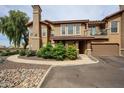 Inviting two-story townhome featuring a private balcony, attached garage, and beautifully landscaped front yard at 14250 W Wigwam Blvd # 2822, Litchfield Park, AZ 85340
