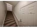 Carpeted stairway with white doors offering a warm welcome at 14250 W Wigwam Blvd # 2822, Litchfield Park, AZ 85340