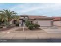 One-story house with a two-car garage and mature desert landscaping at 16019 W Kino Dr, Surprise, AZ 85374