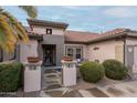 Front entry of a home with decorative pots and a metal gate at 16019 W Kino Dr, Surprise, AZ 85374