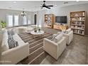 Spacious living room with comfortable seating and built-in shelves at 16187 W Port Royale Ln, Surprise, AZ 85379