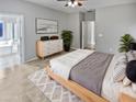 Bright bedroom with ensuite bathroom and wood dresser at 16187 W Port Royale Ln, Surprise, AZ 85379