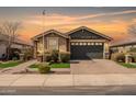 Charming single-story home featuring a two-car garage and desert landscaping at 18716 N Jameson Dr, Maricopa, AZ 85138