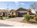 Inviting single-story home with a paved driveway and a beautifully landscaped yard at 18716 N Jameson Dr, Maricopa, AZ 85138