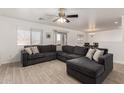 L-shaped sectional sofa and tile flooring in living room at 18907 N Vemto St, Maricopa, AZ 85138