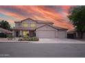 Two-story home features a three-car garage and desert landscaping against a beautiful sunset sky at 2073 E Wildhorse Dr, Chandler, AZ 85286